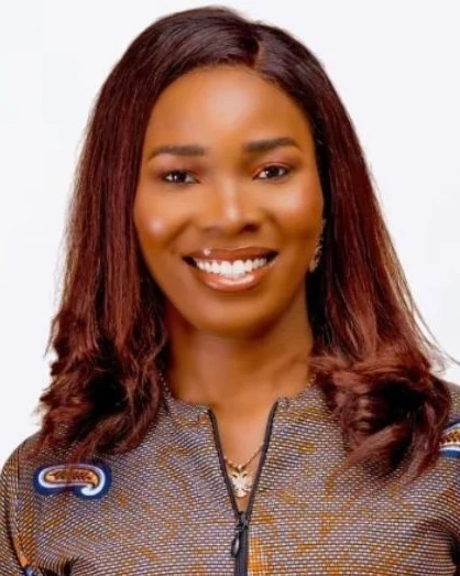 Blessing, lead advisor at B$B Empire, smiling in a patterned top